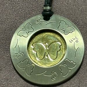 Manuel Zed stainless steel and gold tone butterfly pendant.   Made in It…